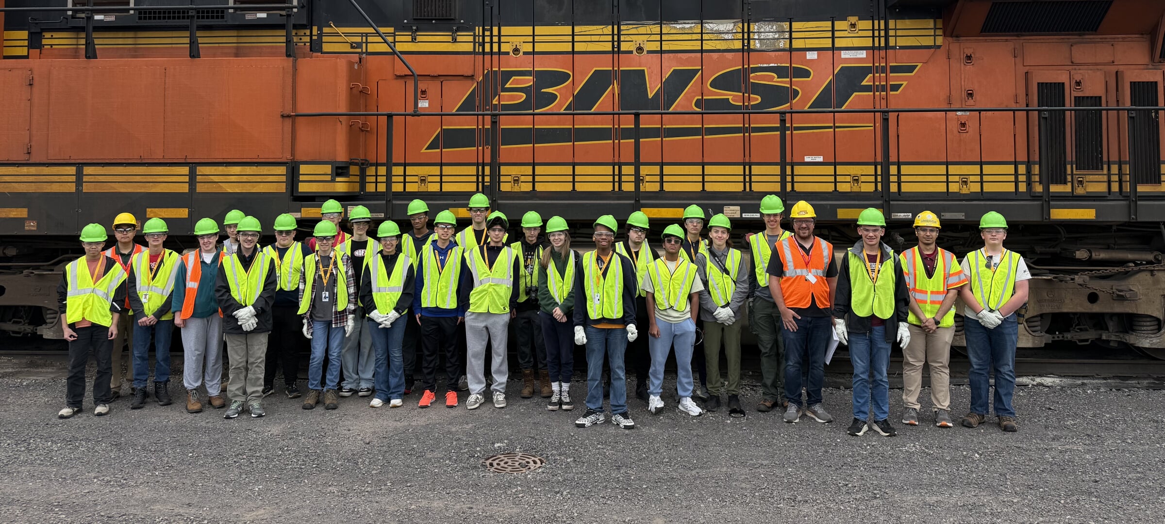 Large group of diverse students outside a railroad museum