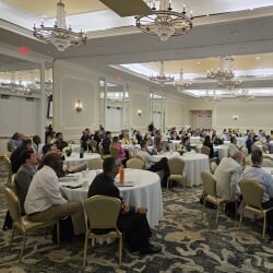 Attendees listen to a presentation at MRC
