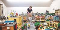 Dennis Livesay adjusting some Legos on his giant city.