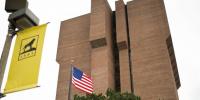 The Michigan Tech ME-EM building, with the Tech 1995 logo and an American flag in the foreground, is the center for a new national program run by the Department of Commerce offering $5.4 million in funding potential to support faculty and student researchers.