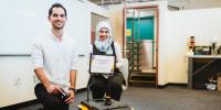 Amna Mazen and Kamyab Yazdipaz with the award and robot.