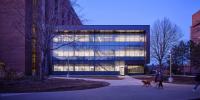 The H-STEM Complex at dawn with people walking in front.