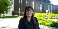 Kelly Kamm smiles outdoors on a sunny day on Michigan Tech’s campus.