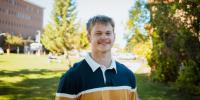 Jim Brisson standing on campus in early autumn.