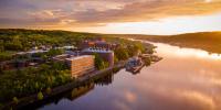 Aerial shot of Michigan Tech’s campus from over the Keweenaw Waterway during a sunset.