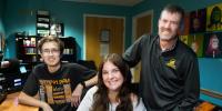 Two Michigan Tech students and their classroom instructor together in the WMTU DJ booth.