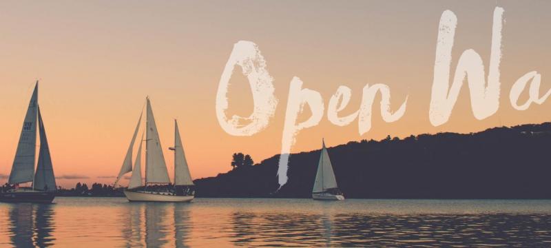 Sail boats on the water during sunset.