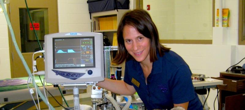 Erika Crook next to medical equipment.