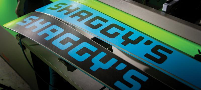 Skis with the Shaggy's logo on them.