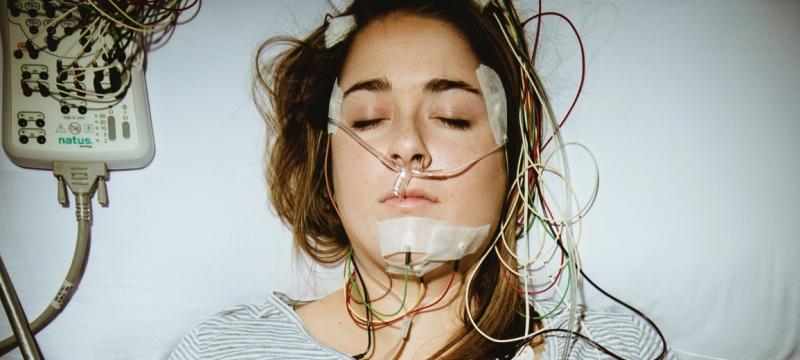 Woman hooked up to monitors sleeping.