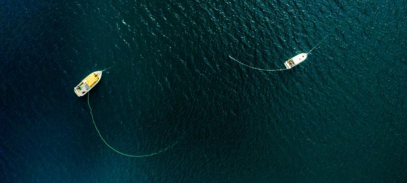 Overhead view of two boats on the water.