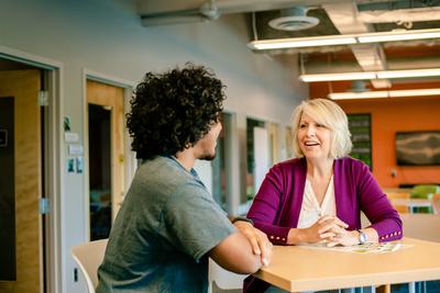 Man and woman talking at a table