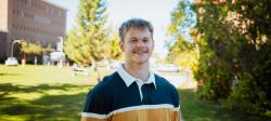 Jim Brisson standing on campus in early autumn.