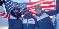 Deedra Irwin and two teammates hold up a US flag at the Olympics.