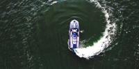 Unmanned waverunner making a circular wake in the water.