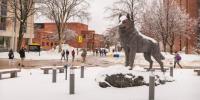 The Michigan Tech campus and Husky statue covered in snow during winter