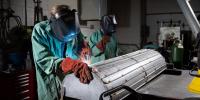 PSTLD researchers weld liquid nitrogen lines onto a custom thermal shroud