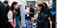 A Michigan Tech student talks to a recruiter at Career Fair, where thousands of interviews will be landed as students and companies meet.