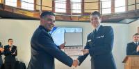 An Air Force ROTC cadet receives an unmanned systems award from his commander at Michigan Tech