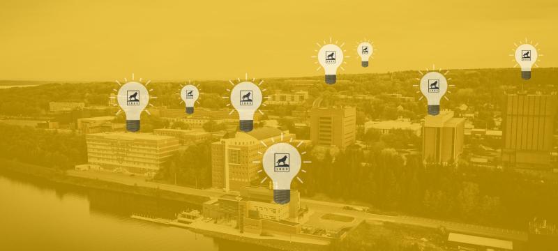 Yellow overlaid photo of campus with lightbulbs on various buildings.