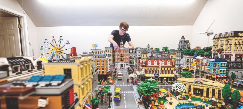Dennis Livesay adjusting some Legos on his giant city.