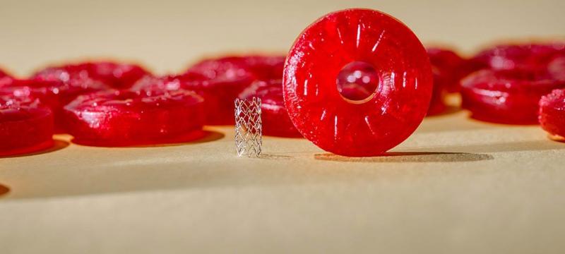 A zinc stent next to a Life Saver candy for a sense of scale
