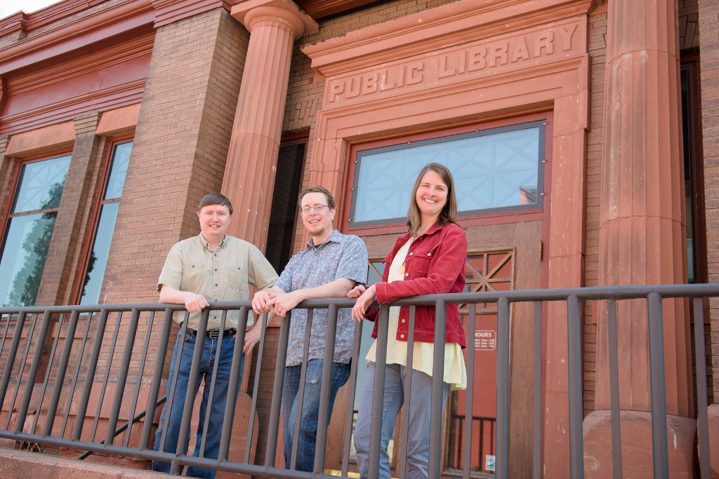 From left, Don Lafreniere, John Arnold and Sarah Scarlett are scene in front of one of their cooperating sites, Houghton's Carnegie Museum. Their project, Keweenaw Time Traveler, has received a $259,882 grant from the National Endowment of the Humanities.