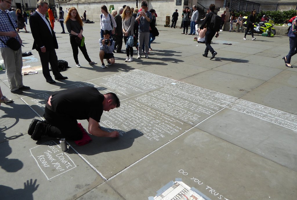 A demonstrator chalks his pro-Brexit beliefs on a sidewalk near Trafalgar Square.