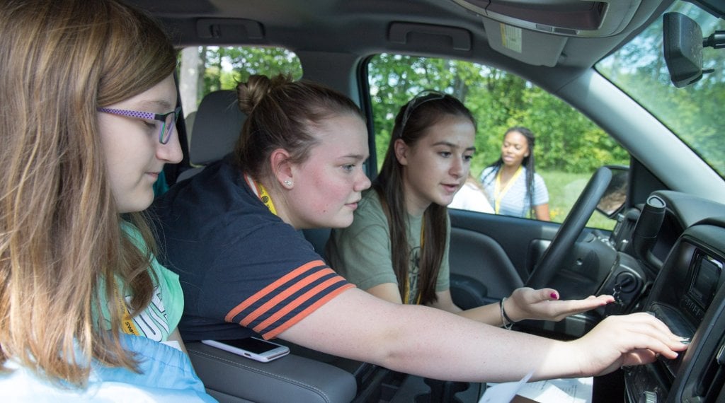 From the left, Megan Rylko, Ashley Curtin and Zoe Rozine get a hands-on look at automotive engineering as a career.