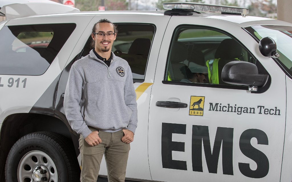 Mario Calabria with one of the Michigan Tech EMS vehicles.