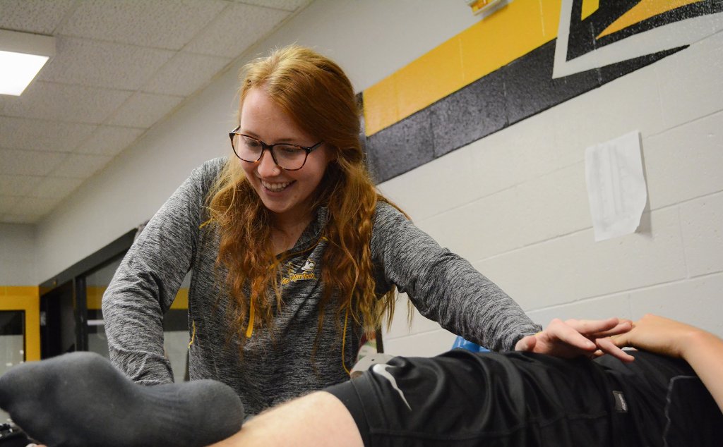 Hali Evans, a participant in Michigan Tech's Athletic Training Internship Program treats a student athlete. Evans, en exercise science major, is one of five recipients of the Portage Health Foundation/Randy Owsley Memorial Scholarship.
