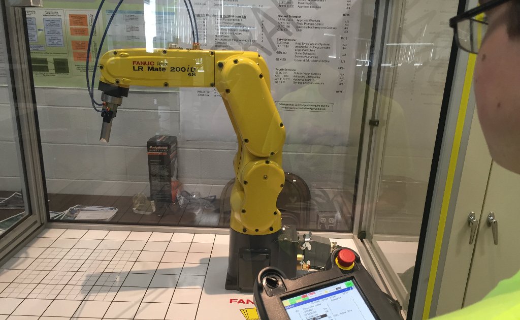 Michigan Tech and Bay College are partnering to teach students the theory and operation of Fanuc robots, like the one shown here.