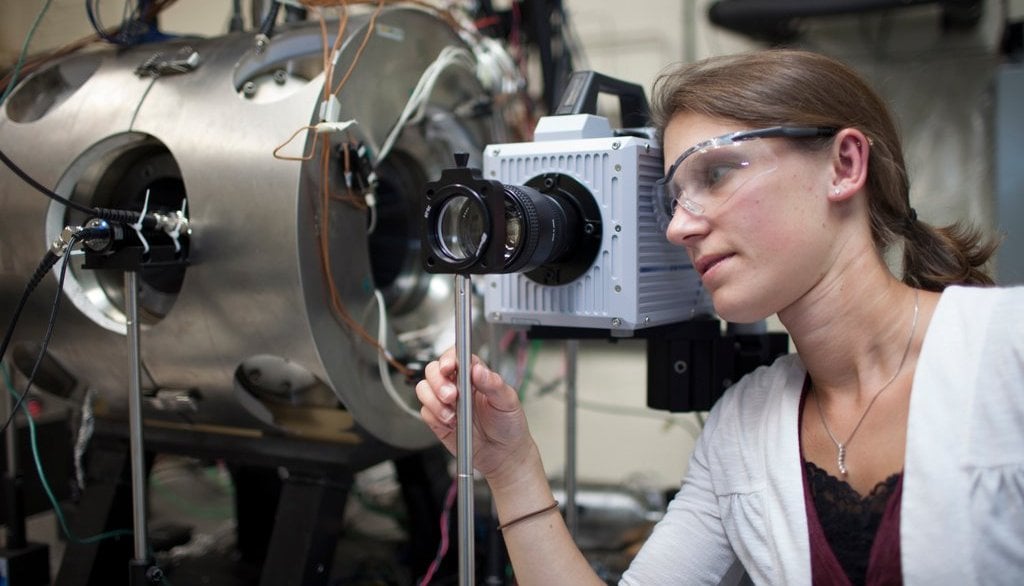 Jaclyn Johnson prepares to do laser diagnostic measurements in an optically accessible combustion vessel.