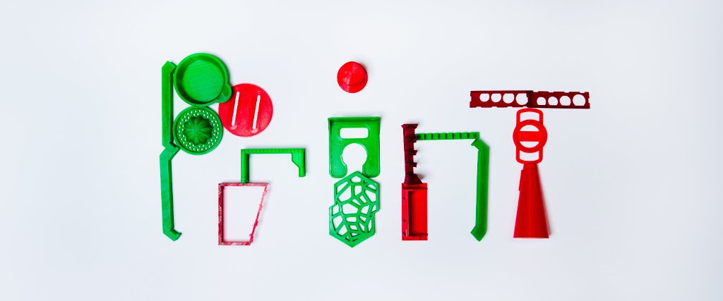 The team assembled 26 items printed with the Lulzbot Mini, including parts for a Christmas tree stand, a juicer, tool holders, a soap dish, a bathroom wine glass holder, a camera lens holder, parts of a coin holder, and a shaving brush stand.