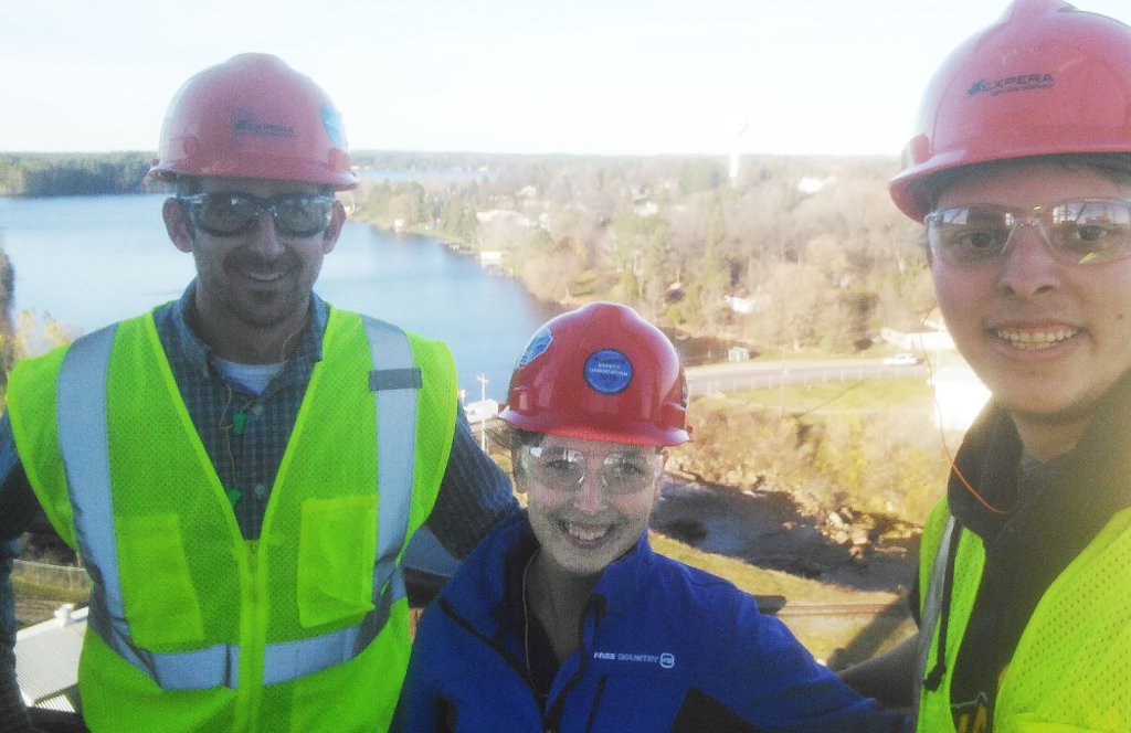 Environmental Engineering major Sarah Jo Marten, center is shown at the 100 ft. mark of the coal-fired power plant exhaust stack in Rhinelander, Wisconsin. Martens was on co-op with Expera Specialty Solutions last fall. Also pictured is, left, Expera Engineering Supervisor John Harris and Michigan Tech Mechanical Engineering student Brian Roman, who was also on co-op.