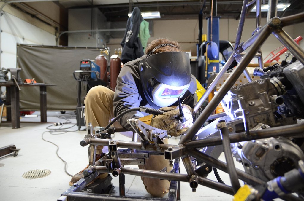 A students welds parts of the chassis on a Formula One racecar, part of the SAE International collegiate competition. The photo won first place in the Design Expo image contest.