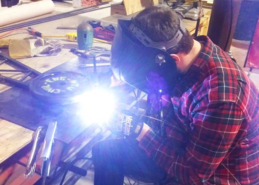 Welding on Steel Bridge A Steel Bridge Team member welds a part on their bridge.