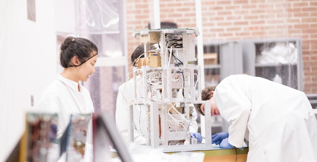 The students work in the Aerospace Enterprise Class 100,000 Clean Room.