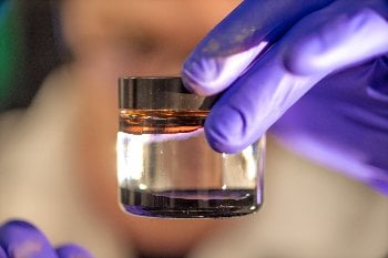 Without a magnetic field, ferrofluids look like a tarry, oil-based fuel. With a magnetic field, the propellant self-assembles, raising into a spiky ball. 