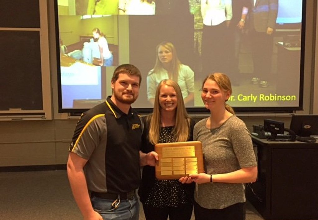 Michigan Tech Alumna Carly Robinson, Center presents the Michigan Tech Physics Department's 2017 Ian W. Shepherd Award to Ben Manning and Kelci Mohrman. Manning has also been awarded a Woodrow Wilson National Fellowship.