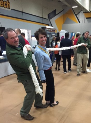Career Fair visitors tug on twisted ropes of paper towels.