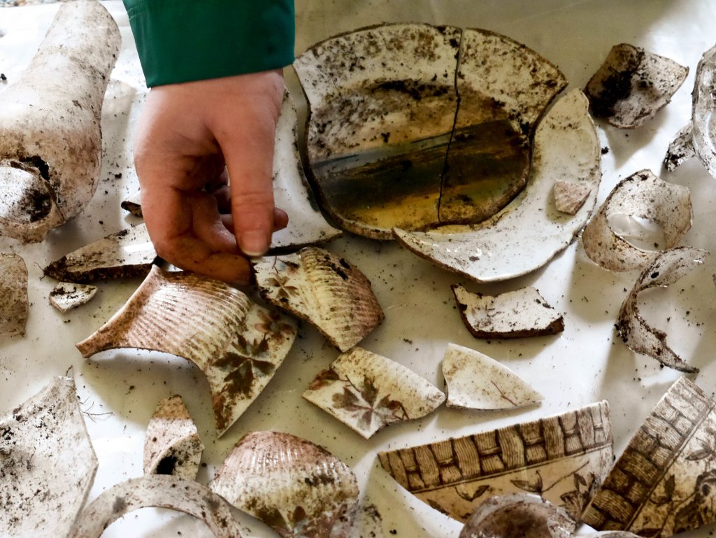 A student sorts through pieces of ceramic excavated at the range light keeper's house privy in Copper Harbor, Michigan, as part of an archaeological dig for Fort Wilkins Historic State Park.