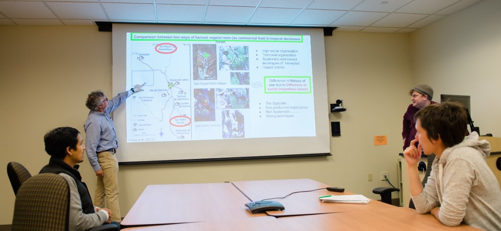 Professor Alex Mayer, standing left, makes a point in his international ecosystems seminar. Students are Sergio Lopez Ramirez, seated left; Ken Thiemann, standing right, and Ande Myers, seated right.