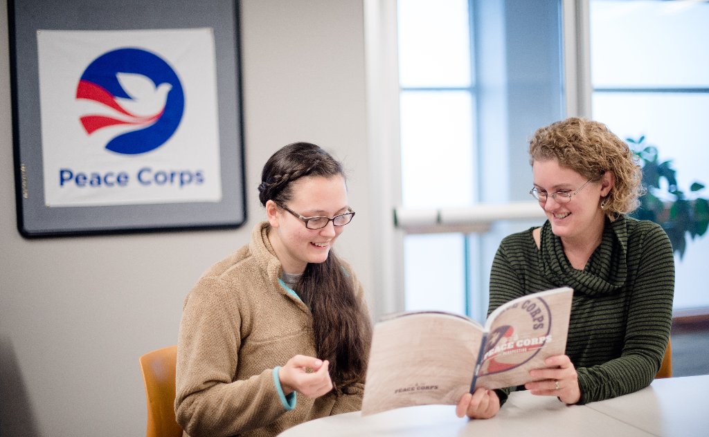 Kari Henquinet, right, shares Peace Corps information with Peace Corps Prep student Laura Schimmel, left.
