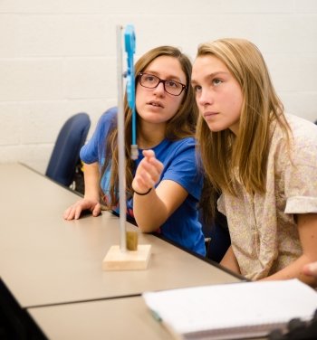 students and a pendulum clock