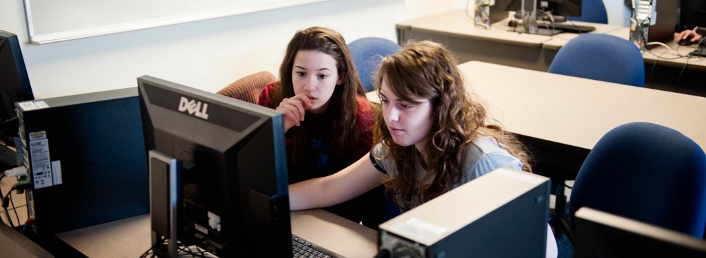 High school students working at a computer.