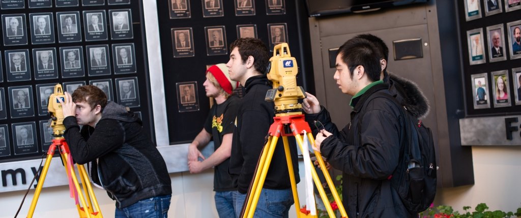 Students using surveying equipment