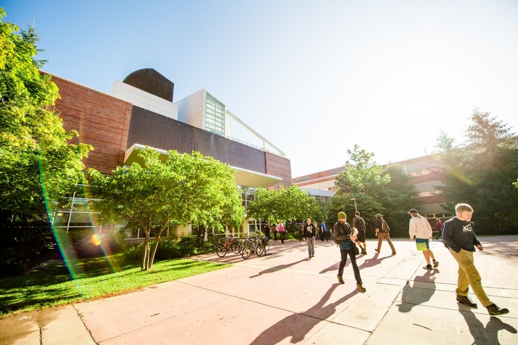 Students walking through campus mall in the springtime. 