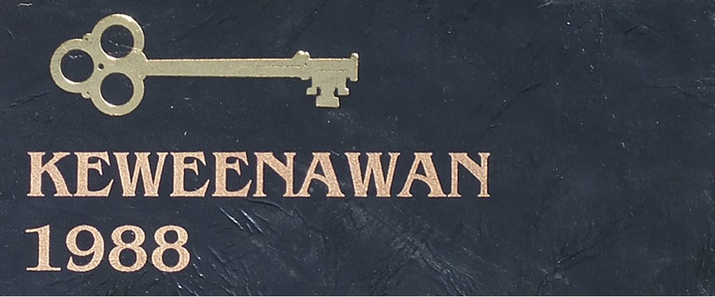 a key the words keweenawan an 1988 on the cover of a black leather yearbook