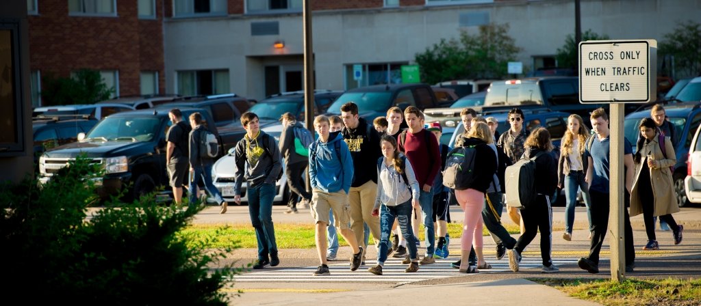 Students walk across campus in the early fall